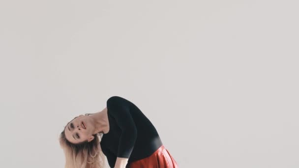 Mladá krásná baletka tančí na bílém pozadí. Červenou sukni vlající. Projekt baletka. — Stock video