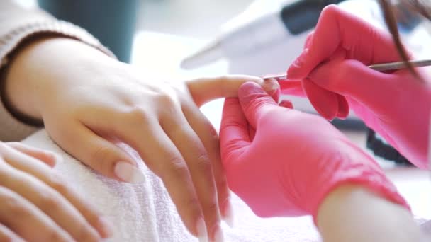 Close-up of manicurist removing cuticle from the nail — Stock Video