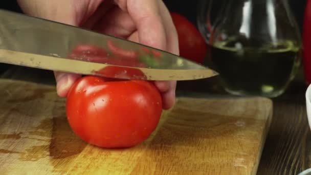 Hands slicing tomato in kitchen — Stock Video