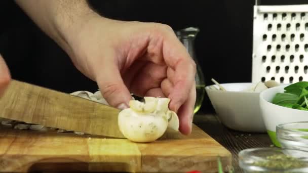 Mans mãos cortando cortando cogumelos champignon de Paris legumes na cozinha, close-up — Vídeo de Stock