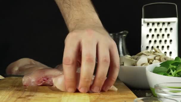Butcher chopping through turkey meat — Stock Video