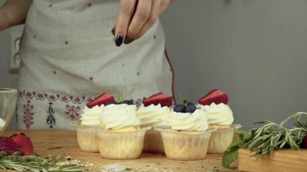 Bunte Schokoladenchips fallen auf einen Cupcake — Stockvideo