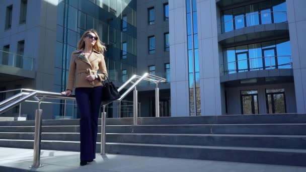 La mujer de negocios es enviada al edificio de oficinas para una reunión. Cuando sube las escaleras mira el reloj. Tiene miedo de llegar tarde a una reunión importante. filmado en cámara lenta — Vídeos de Stock