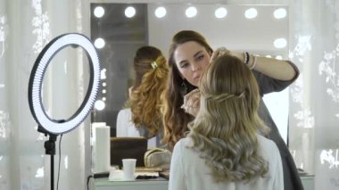 Bir makyaj master modeli görüntü güzellik salonu'için hazırlar. Makyaj sanatçısı, profesyonel bir makyaj yapar.
