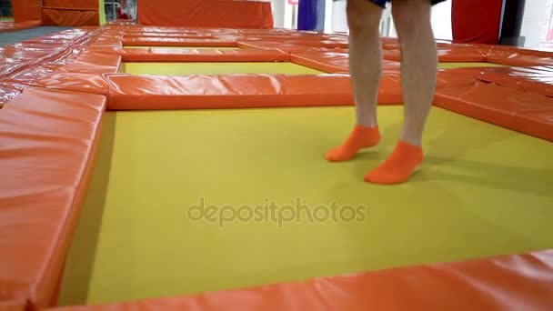 Young Men Jumping At Trampoline In Indoors Playground. Active People Male Having Fun At Sport Center. Slow Motion — Stock Video