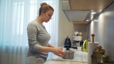 Genç bir kız evde mutfakta yemek pişirirken elleri yandı.