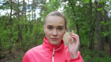 Sonbahar Park'ta çalışan ve kulaklık ile müzik dinlemek genç güzel kadın.