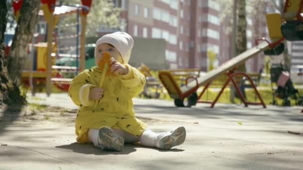 Cheerful funny kid playing at children playground on autumn day. — Stock Video