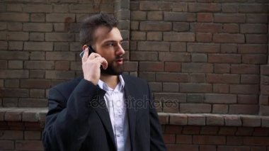 Eski duvar boyunca, steadicam, açık yürüyüş smartphone, konuşan adam