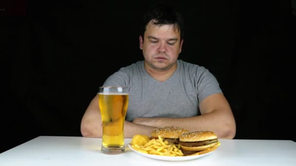 Dieta falha do homem gordo comer hambúrguer fast food. Feliz sorriso pessoa com excesso de peso que estragou a comida saudável por comer hambúrguer enorme em garfo. Refeição de lixo leva à obesidade. Recusa de alimentos nocivos . — Vídeo de Stock