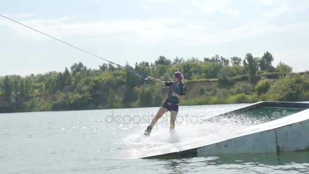 Woman jumping on wakeboard, splash. — Stock Video