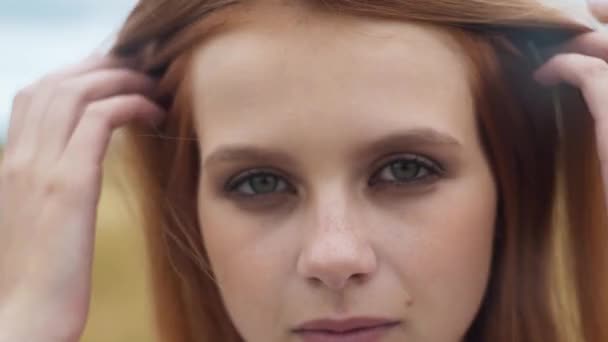 Portrait of a young girl sitting in a wheat field — Stock Video