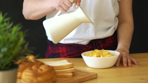 Milk pouring into cereal bowl in slow motion — Stock Video