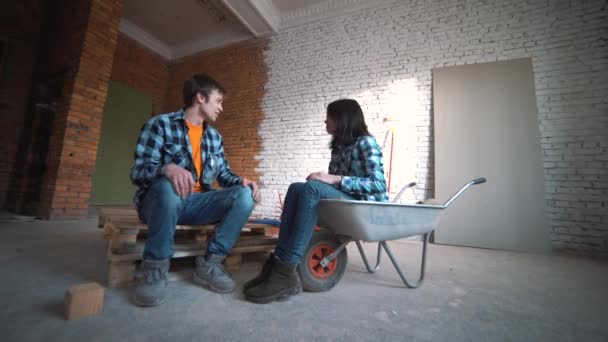 Verliefde paar planning een renovatie in het nieuwe huis. — Stockvideo