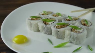 Suşi seti masada. Restoranda çeşitli Japon yemekleri servis edilir. Somon, ton balığı, sebze, uçan balık Roe ve havyar yakın plan..