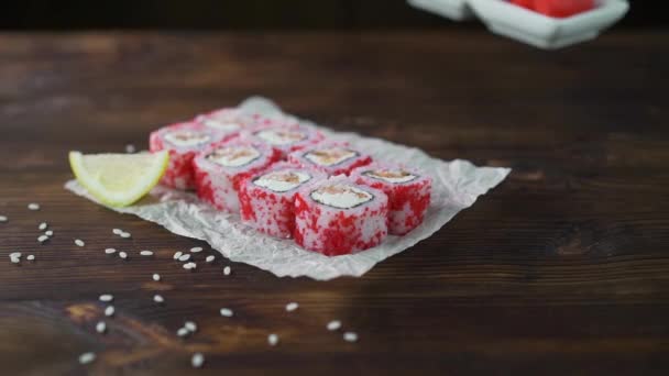 Sushi roll set on the table. Various Japanese dishes are served at the restaurant. Set with salmon, tuna, vegetables, flying fish ROE and caviar close-up. — Stock Video