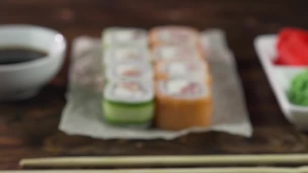 Sushi roll set on the table. Various Japanese dishes are served at the restaurant. Set with salmon, tuna, vegetables, flying fish ROE and caviar close-up. — Stock Video