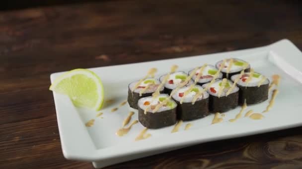 Sushi rolka na stole. V restauraci se podávají různá japonská jídla. Set s lososem, tuňákem, zeleninou, létající rybou Roe a kaviárem zblízka. — Stock video