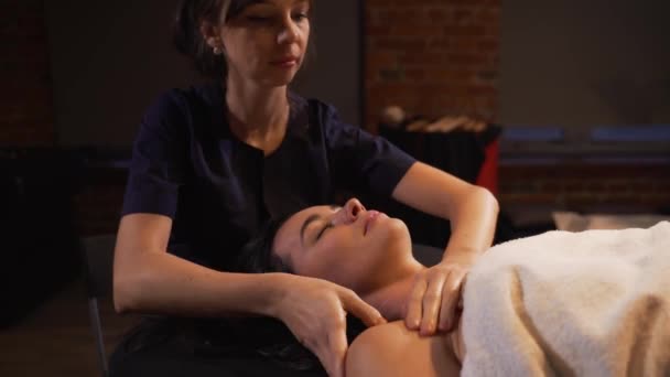 Spa vrouw gezicht Massage. Gezicht Massage in de schoonheidssalon spa. Vrouw genieten van ontspannende massage van het gezicht in cosmetologie spa-centrum. Lichaamsverzorging, huidverzorging, wellness, schoonheidsbehandeling. — Stockvideo