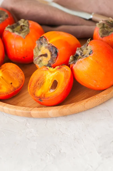 Plate of fresh and ripe persimmons. Close up. — Stock Photo, Image