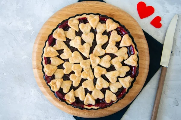 Cherry pie with heart shape decorations from flaky dough on a wh — Stock Photo, Image