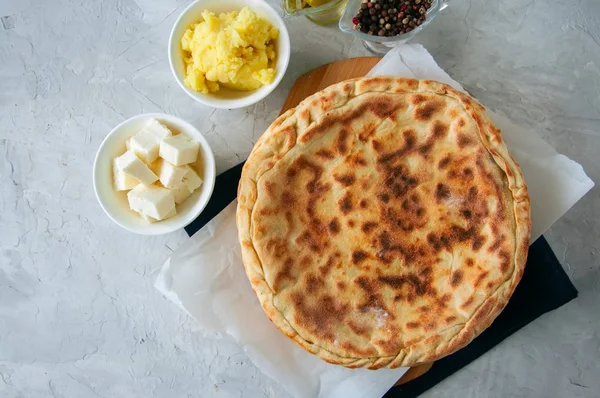 Mashed potato and sheep cheese filling flatbread on a white ston — Stock Photo, Image