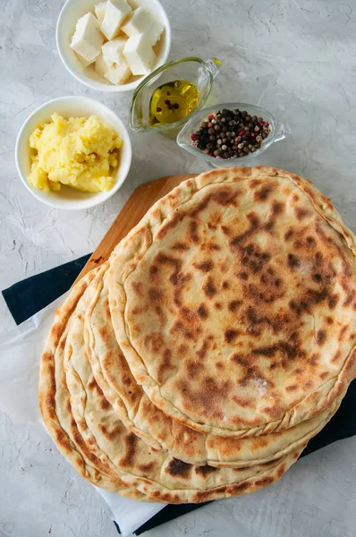 Mashed potato and sheep cheese filling flatbread on a white ston — Stock Photo, Image