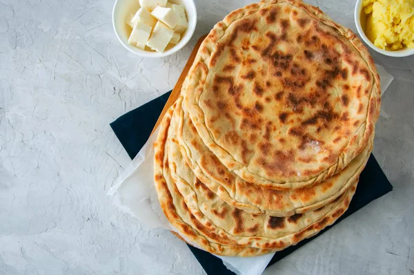 Mashed potato and sheep cheese filling flatbread on a white ston — Stock Photo, Image