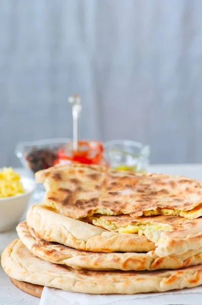 Mashed potato and sheep cheese filling flatbread on a white ston — Stock Photo, Image