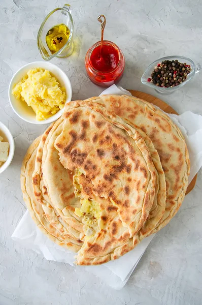 Mashed potato and sheep cheese filling flatbread on a white ston — Stock Photo, Image