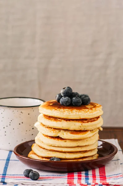 Stack of homemade pancakes with blueberries in a plate, milk in — Stock Photo, Image