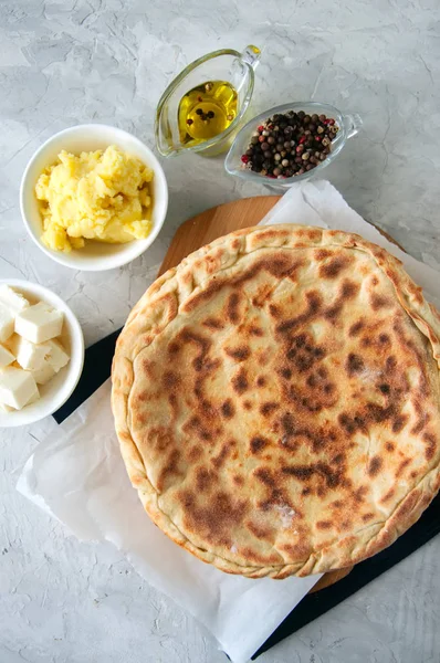 Mashed potato and sheep cheese filling flatbread on a white ston — Stock Photo, Image