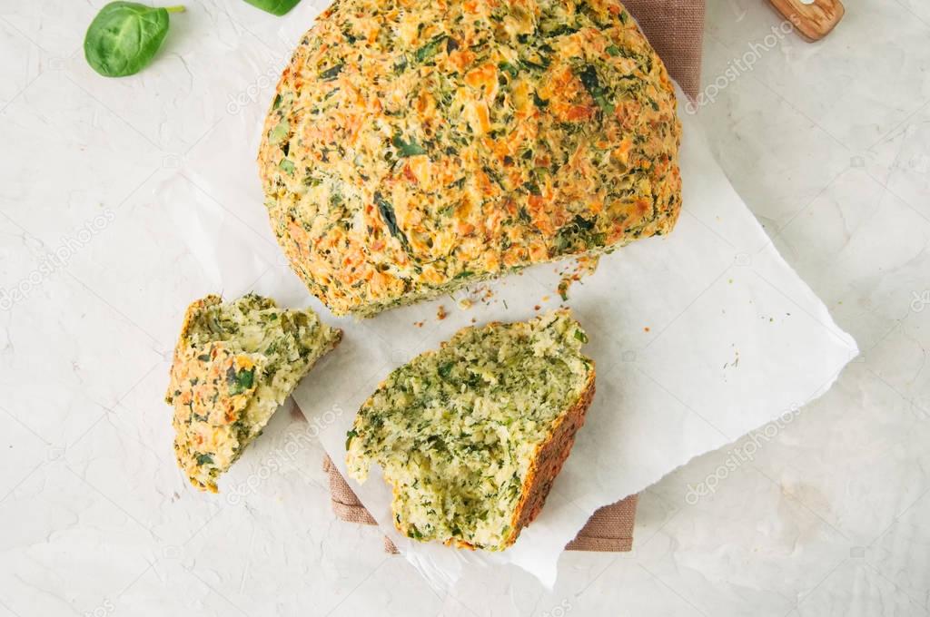 Freshly baked cheesy spinach bread on a white stone backdrop. Ru