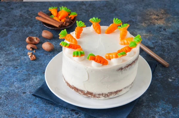 Carrot cake with cream cheese frosting decorated with carrot mar