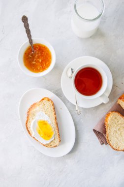 Susam tohumu Challah, portakal reçeli, süt, bir fincan çay üzerinde dilim 