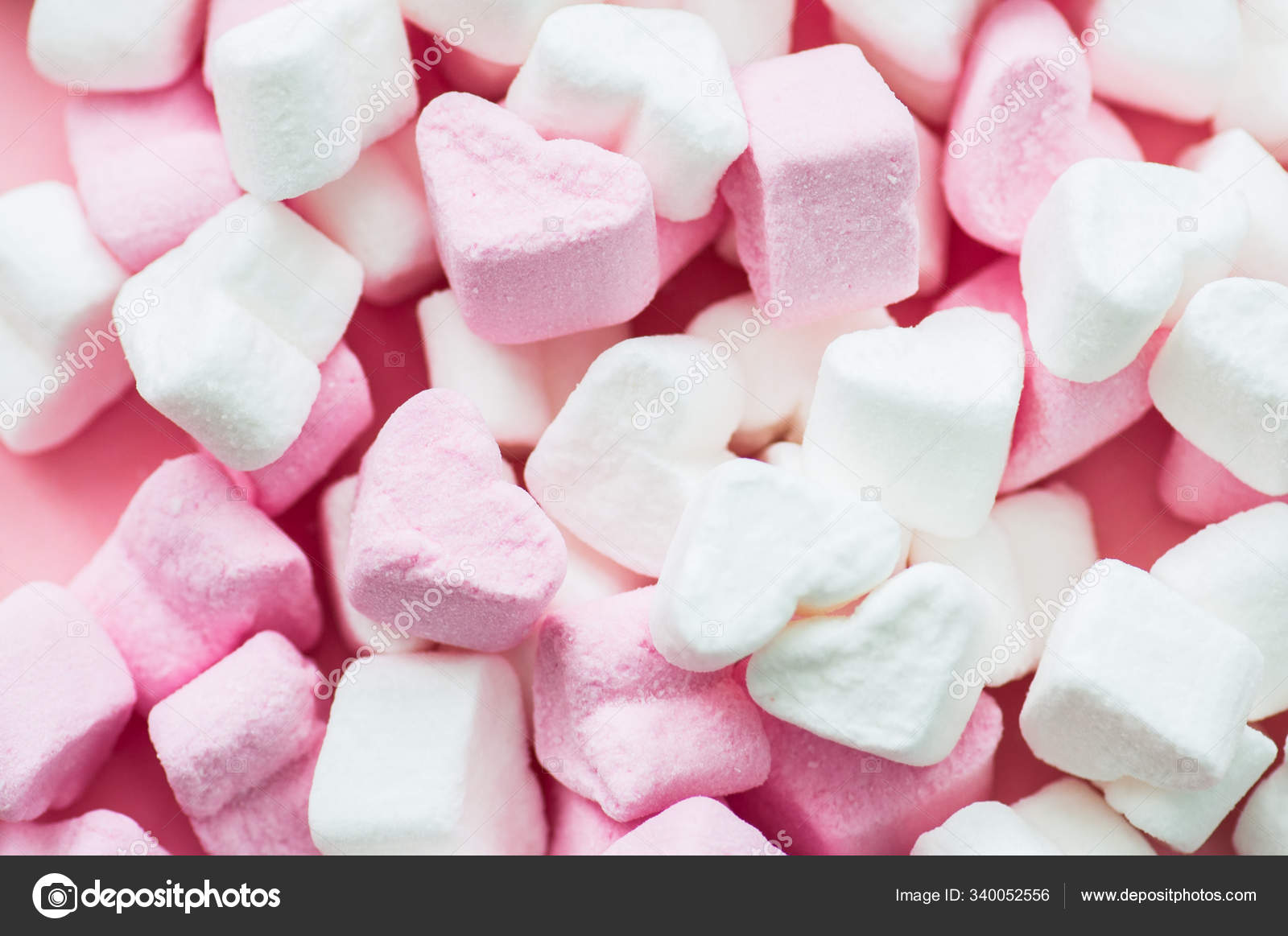 Pink fluffy heart shaped marshmallows candy background. Stock