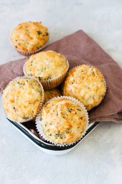 Baharatlı baharatlı otlar ve peynirli çörekler kasede. Beyaz taş arkaplan.