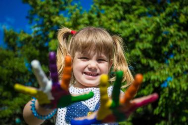 Sevimli kız ellerini gösterilen parlak renklerde boyanmış. El parmak.