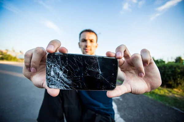 Smart phone with a cracked screen — Stock Photo, Image