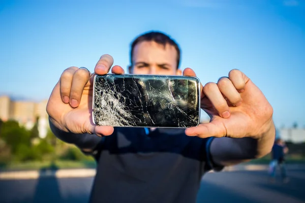 Smart phone with a cracked screen — Stock Photo, Image