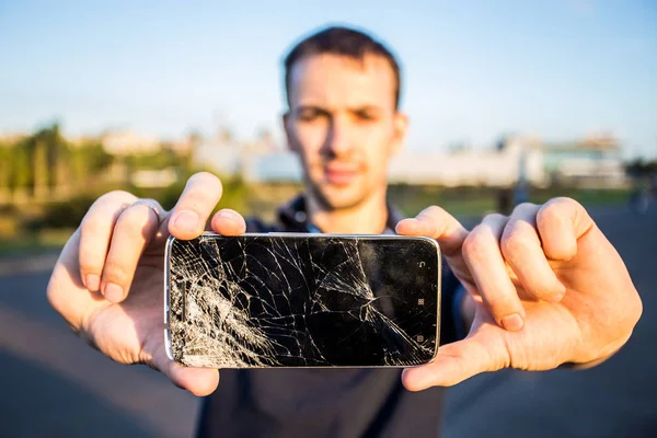 Smart phone with a cracked screen — Stock Photo, Image