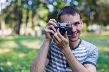Genç adam retro kamera resim çekme