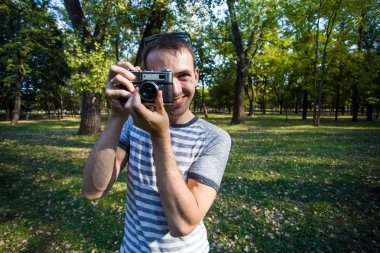 Genç adam retro kamera resim çekme