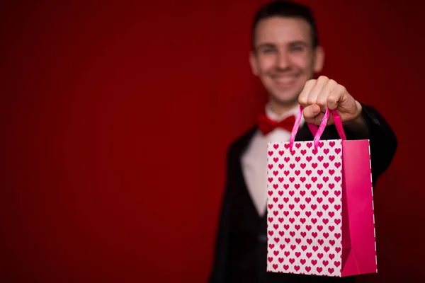 Young Smiling Man Suit Hold Love Gift Bag Red Background — Stock Photo, Image