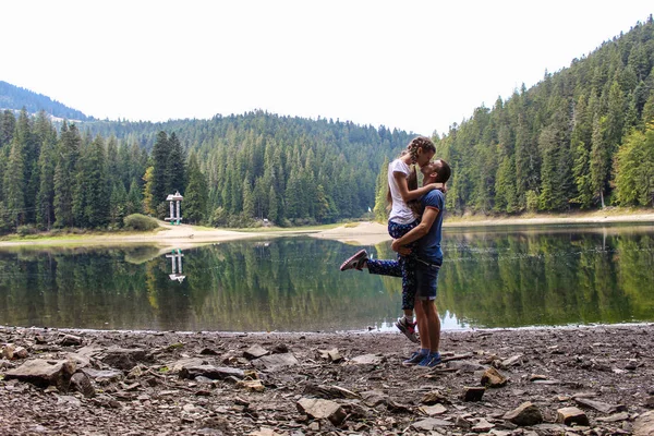 Couple in love hugging near mountain lake