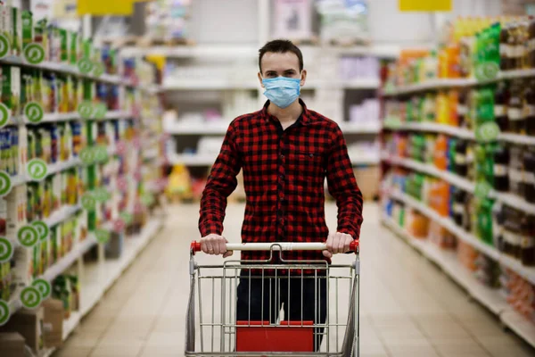 Süpermarkette koruyucu maske alışverişi yapan bir adam salgın sırasında tramvay satıyor..