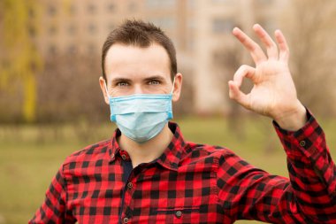 Huzurlu adam koruyucu maske takıyor, el kaldırarak dışarı çık.