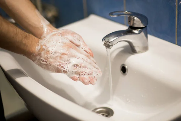 Hygiene concept. Washing hands with soap foam in sink. wash your hands constantly