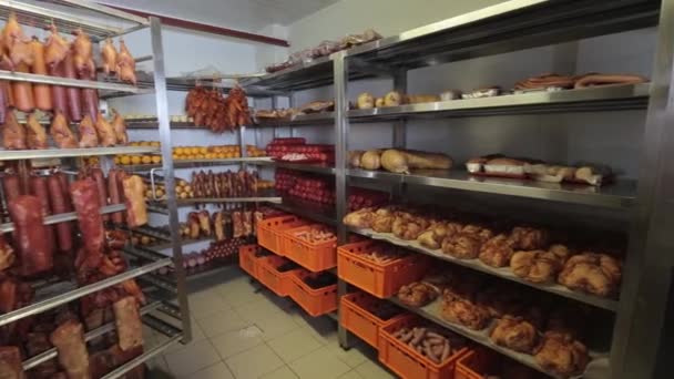 Sticks of salami or sausage suspended by ropes in the fridge. panorama — Stock Video