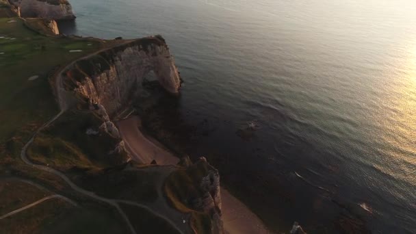 Panoramic Aerial view of Etretat coastline with white chalk cliffs, Aiguille dEtretat, natural stone arch and the beach. Etretat, Normandy, France. — Stock Video